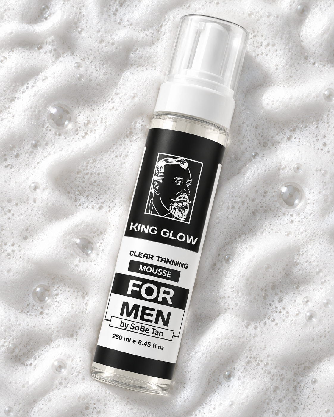King Glow clear, colorless tanning mousse bottle lying diagonally on textured white foam.