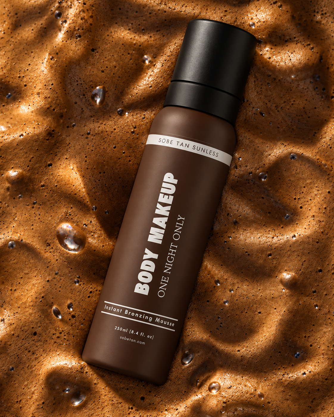 SoBe Tan Body Makeup One Night Only 250 ml mousse bottle lying diagonally on brown foam.