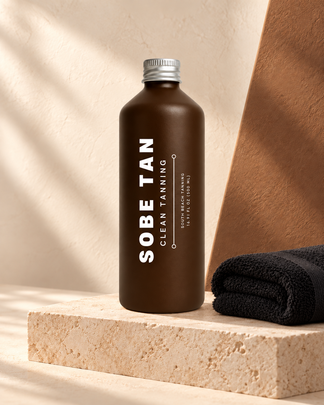 Bienvenido a Miami Body Makeup 500 ml bottle beside a folded black towel